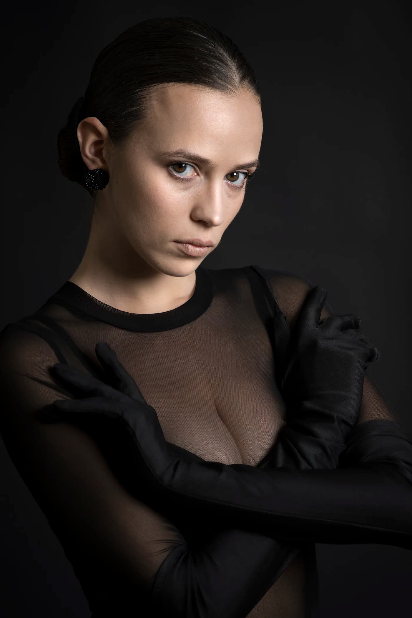 Portrait in sheer black, arms folded